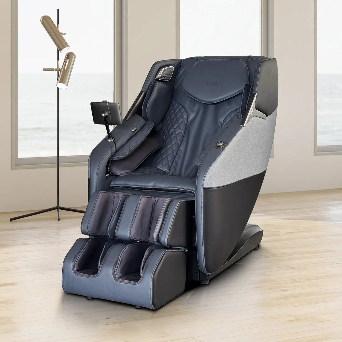 Black Titan Pro 4D Astro massage chair in a sunlit living room with ocean-view windows