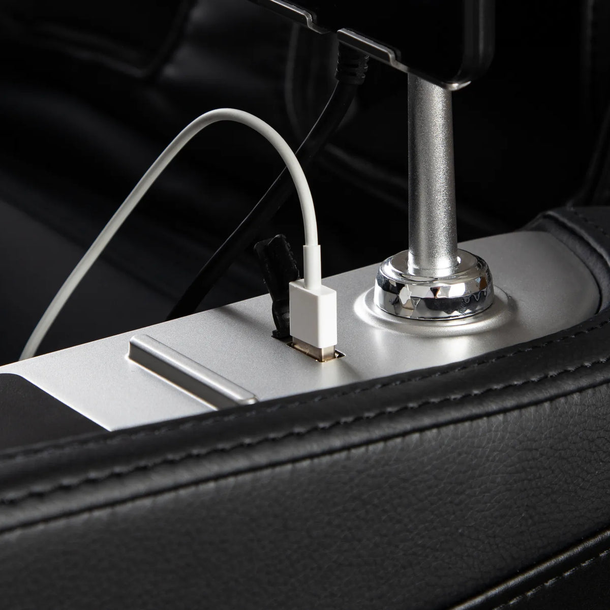 USB-A cable plugged into the armrest charging port of the Black Osaki Aeris 4D Duo
