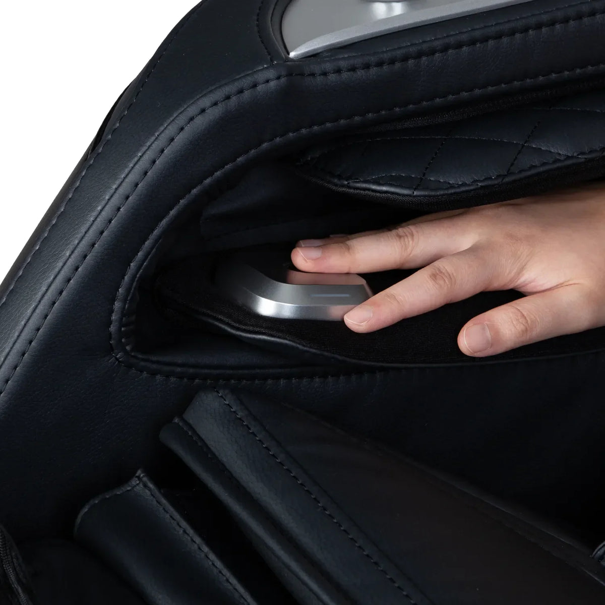 Fingertip resting on the armrest health detection sensor of the Black Osaki Aeris 4D Duo