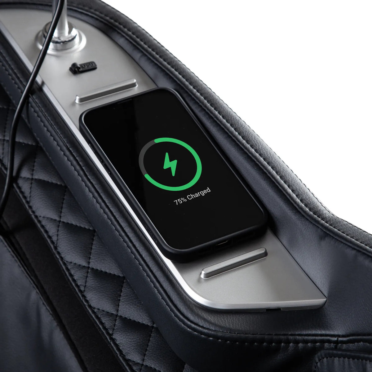 Smartphone charging on the wireless charging pad in the armrest of the Black Osaki Aeris 4D Duo