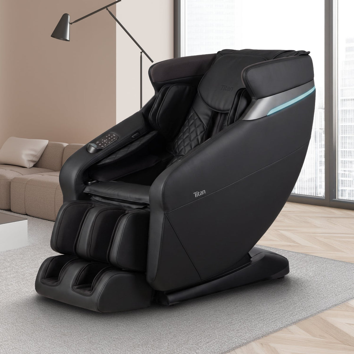 Black Titan Forma 3D+2D massage chair on a rug in a modern living room with a floor lamp