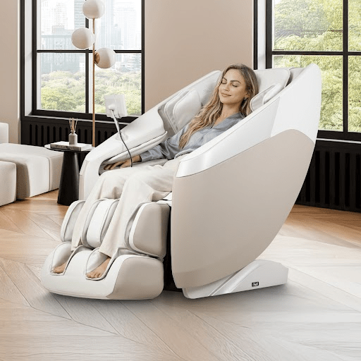 Woman relaxing with eyes closed in a Taupe Osaki Nova II 3D+ massage chair in a sunlit living room
